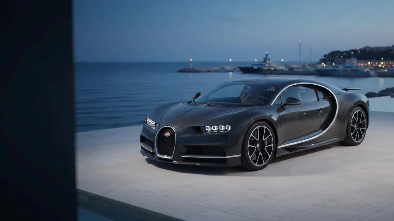 Black Bugatti Chiron beside a private marina